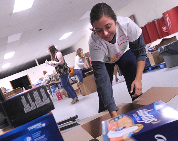 Volunteer Ashley Dikeman,a teacher at St. John the Baptist School, prepares care packages Saturday morning at the Salvation Army, 960 Main Street, for the hurricane Henry relief effort. Difference makers from throughout Western New York  spread out around the Buffalo area to give back to the community with a few hours of service. (Dan Cappellazzo/Staff Photographer)